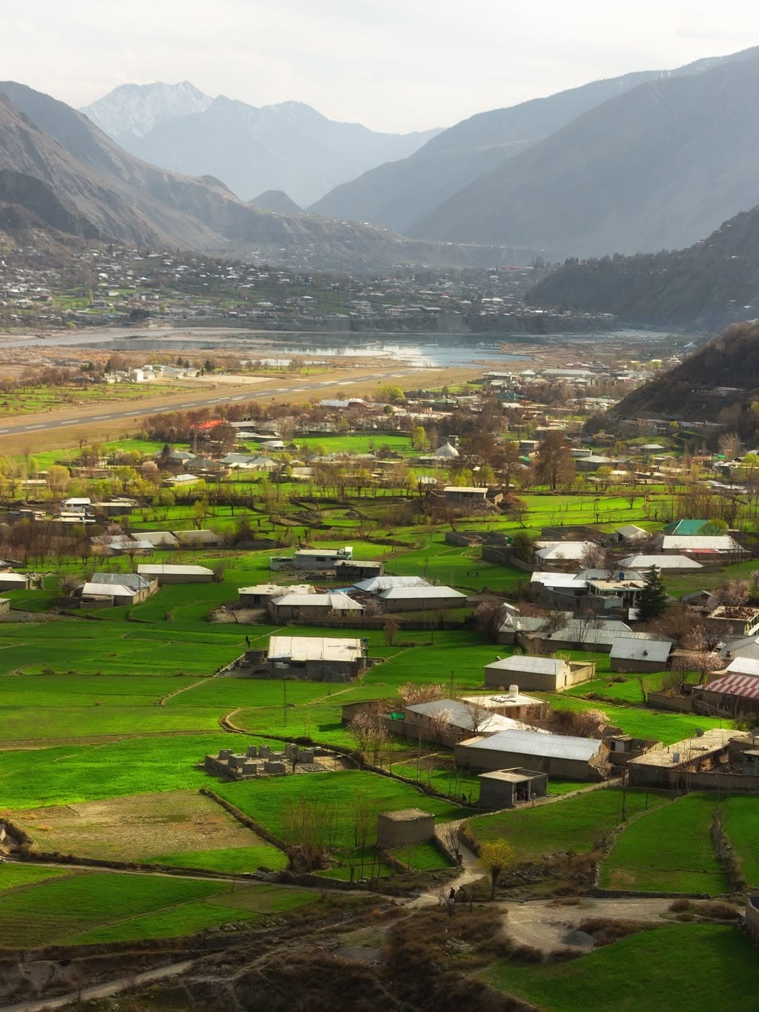 Aerial view of Chitral valley with green fields and river